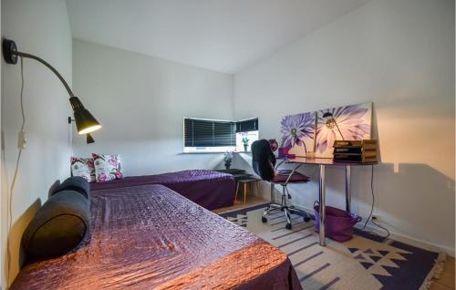 a room with a bed and a table and a desk at Amazing Home In Nimtofte With Wifi in Nimtofte