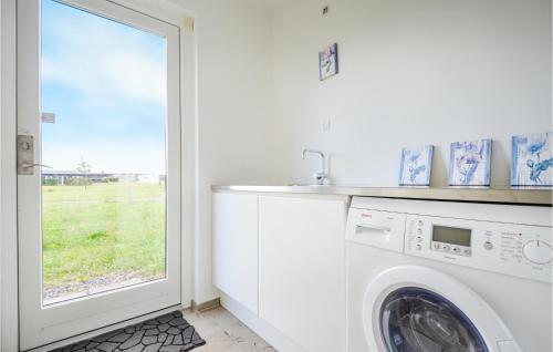 a laundry room with a washing machine and a window at Amazing Home In Nimtofte With Wifi in Nimtofte