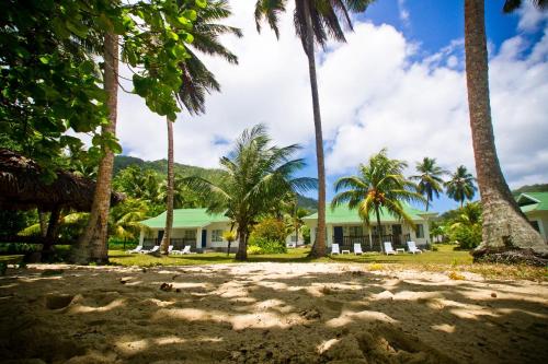 
a sandy beach with palm trees and palm trees at Chalets d'Anse Forbans SelfCatering in Takamaka
