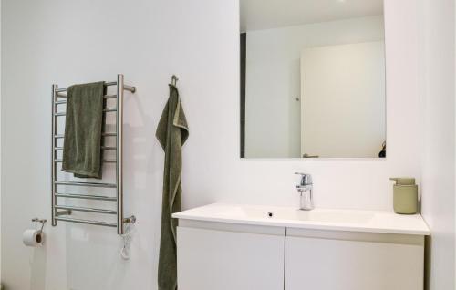 a white bathroom with a sink and a mirror at Awesome Home In Hundested With 2 Bedrooms And Wifi in Hundested