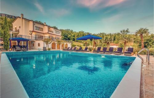 a swimming pool with chairs and a house at Gorgeous Home In Bribir With Outdoor Swimming Pool in Bribir