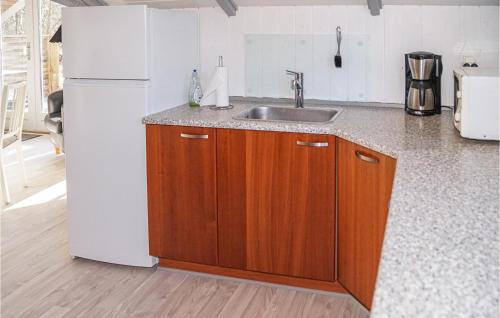 a kitchen with a sink and a white refrigerator at Two-Bedroom Holiday Home In Give in Give