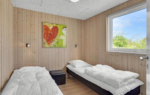 two beds in a room with a window at Amazing Home In Sydals With Indoor Swimming Pool in Høruphav