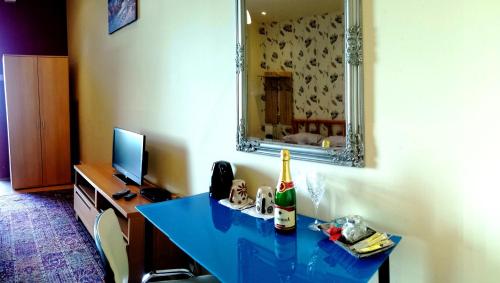 a room with a blue table with a bottle of champagne at Garden House in Budapest