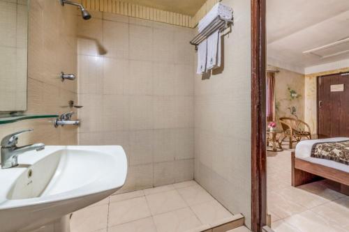 a bathroom with a sink and a bath tub at Sunderban Tiger Camp in Gosāba