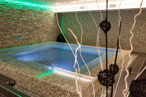 a swimming pool in a room with a brick wall at Hotel 4 Venti spa & wellness in Sestri Levante