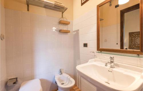 a bathroom with a sink and a toilet and a mirror at Villa Lavinia in Vitorchiano