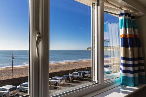 a window with a view of the beach at Mariners Hotel in Seaton