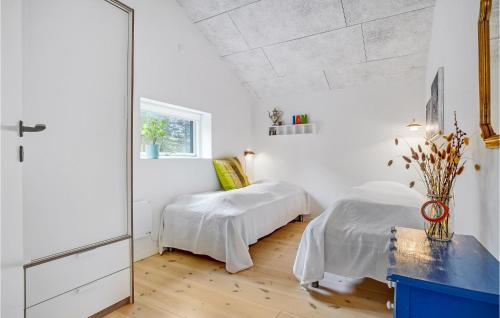 a bedroom with two beds and a mirror at 5 Bedroom Awesome Home In Ebeltoft in Ebeltoft