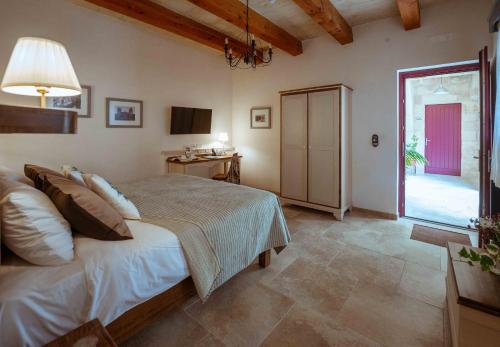 a bedroom with a bed and a large window at Mulberries in Żabbar