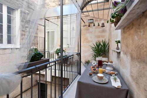 - un balcon avec une table et de la nourriture dans l'établissement Casa di Lo Suites, à Lecce