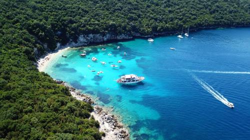 an aerial view of a group of people on a boat in the water at Baia Blu Apartments in Syvota
