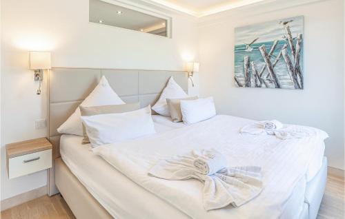 a bedroom with a white bed with two bows on it at Pearl in Binz