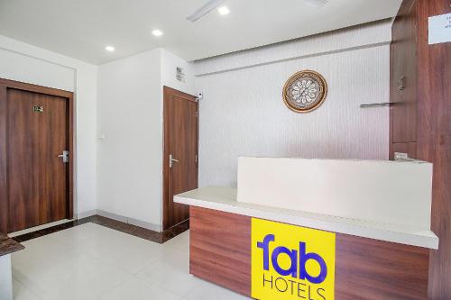 a hotel room with a clock on the wall at FabExpress Comfort Stay I in Bhopal
