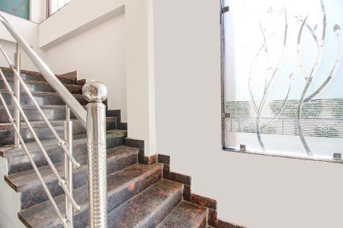 a staircase in a house with a window at FabExpress Comfort Stay I in Bhopal