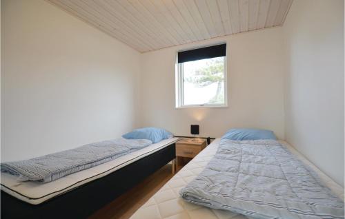 two beds in a room with a window at Gorgeous Home In Ebeltoft With Wifi in Ebeltoft