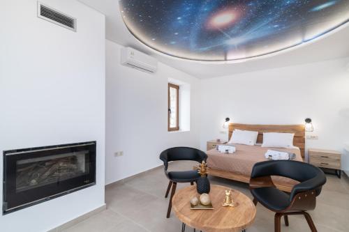 a bedroom with a bed and a fireplace at Villa Foteini in Skinária