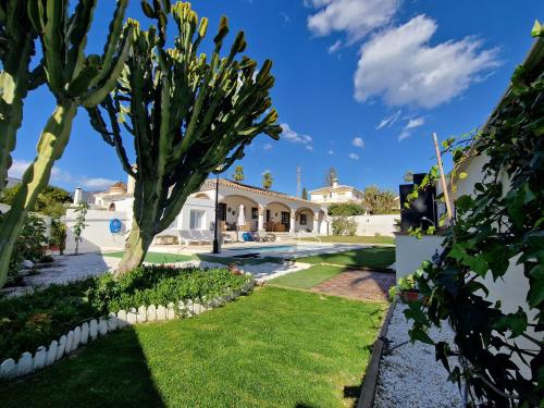 a house with a garden with a cactus at Villa Las Niñas Costa del Sol in Mijas