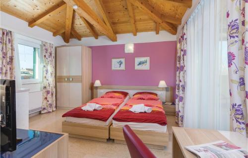 a bedroom with a bed with red sheets and red pillows at Gorgeous Home In Rezanci With Jacuzzi in Režanci