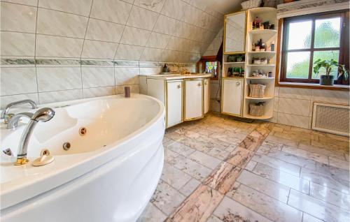 a large bathroom with a tub and a refrigerator at 3 Bedroom Beautiful Home In Hovs in Hovås