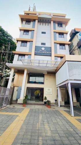 a large building with a walkway in front of it at Hotel Plaza Heights by RAK Rooms, Mangaluru in Mangalore