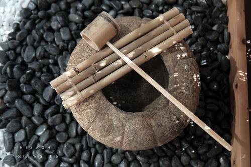 a bowl of black beans with wooden sticks at 久HISASHI 今池 Nagoya in Nagoya