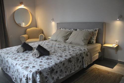 a bedroom with a bed and a chair and a mirror at City Center Apartment 1 in Alexandroupoli