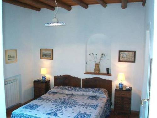 a bedroom with a bed with two night stands and two lamps at Residence il Baglio in Porto San Giorgio
