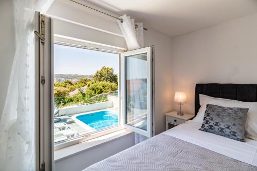 a bedroom with a bed and a window with a view at Holiday Home Sevid in Sevid