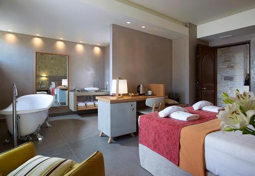 a bathroom with two beds and a bathtub and a bathroom with a bath tub at Mistral Hotel - For Solo Travelers in Maleme
