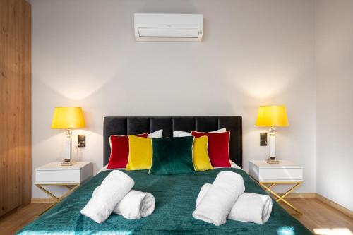a bedroom with a large bed with colorful pillows at Rezydencja Strążyska & Chalet BBQ in Zakopane