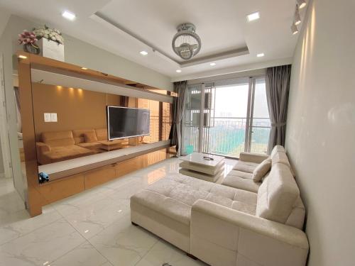 a living room with a couch and a television at Scenic Valley Marvel in Ho Chi Minh City