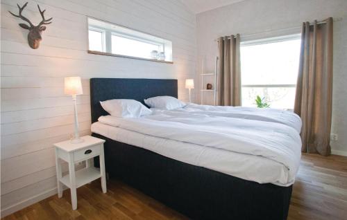 a bedroom with a large bed with white sheets at 4 Bedroom Gorgeous Home In Skillingaryd in Skillingaryd