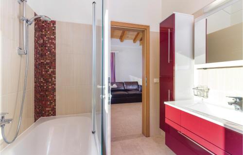 a bathroom with a shower and a tub and a sink at Nice Home In Rezanci With Wifi in Režanci