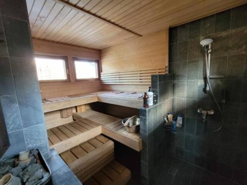 a bathroom with a sauna with a shower and a tub at Room by Lake 10 minutes from Tampere centrum in Lempäälä