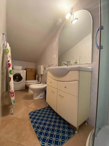 a bathroom with a sink and a toilet at Luci in San Vincenzo
