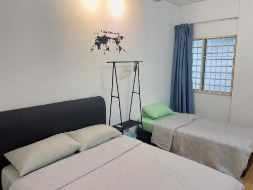 a room with two beds and a map on the wall at Greenlane 4-bedroom landed home (12 pax) in Gelugor