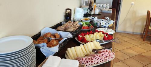 a buffet of food with plates and appetizers at TarmarPlace in Jardim do Mar