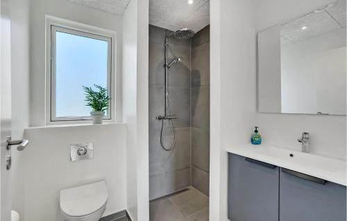 a bathroom with a shower and a toilet and a sink at 4 Bedroom Stunning Home In Løgstrup in Løgstrup