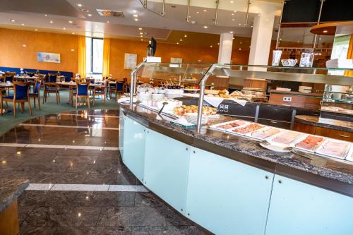 a buffet line with food on display in a restaurant at Hotel Seehof Haltern am See in Haltern