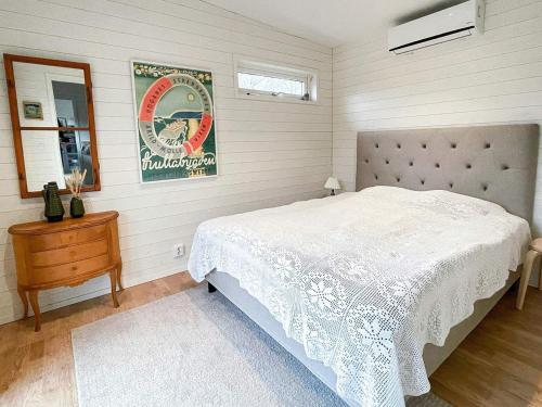 a bedroom with a white bed and a mirror at 4 person holiday home in FARHULT-By Traum in Farhult