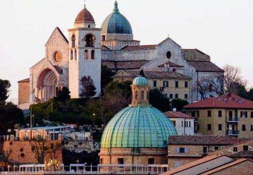 a group of buildings with domes and a church at Il Balcone Sul Corso in Ancona