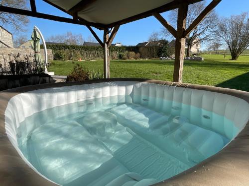 a hot tub in a backyard with a gazebo at Le gîte d’Hayen in Sprimont