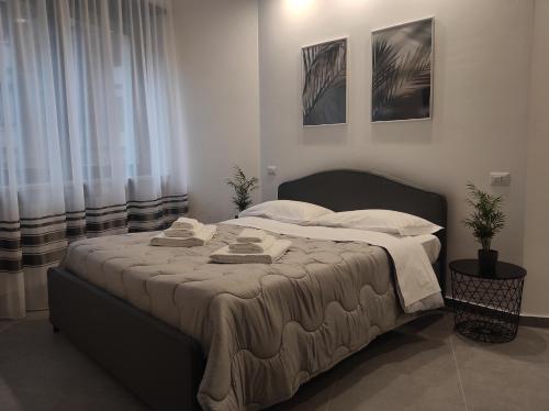 a bedroom with a large bed with towels on it at Residenza Via Verdi in Parma