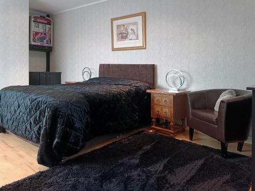 a bedroom with a bed and a chair at The Tides in Cleethorpes