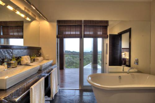 a large bathroom with a tub and a large window at Eden Rock Forest Estate in Pennington