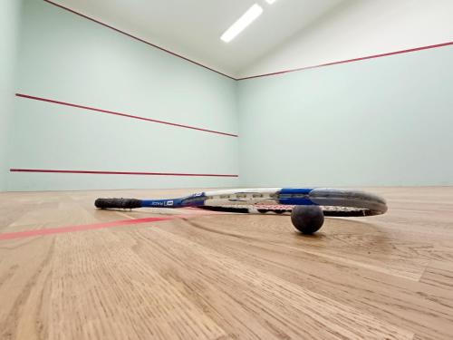 a tennis racket laying on the floor in an empty room at Apartament nad Zalewem in Serock