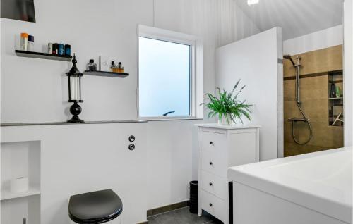 a white bathroom with a sink and a window at Amazing Home In Skibby With Kitchen in Skibby