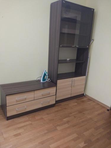 a room with a dresser and a large tv at Апартаменти Volodymyra Velykoho in Ivano-Frankivsʼk