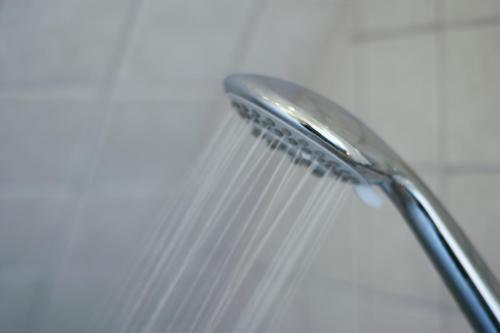a shower head with water coming out of it at Mosters Bed & Breakfast in Guldborg